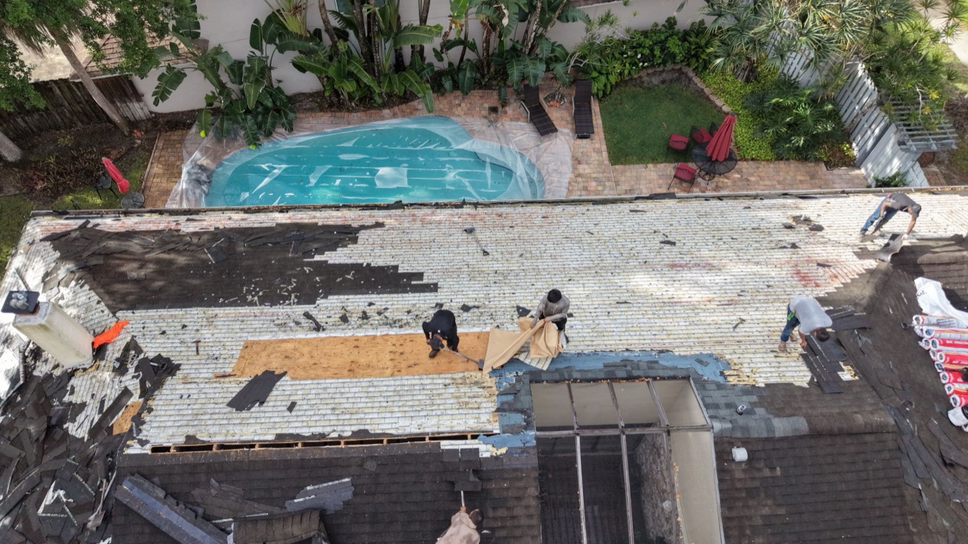 Tear-off — Kaizen Roofing roof replacement in Miami-Dade: Old roofing removed, deck exposed (drone)
